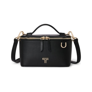 Black Tumi Voyageur Lex small train case crossbody bag with gold hardware, compact and stylish for travel and everyday use.