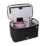 Black Tumi Voyageur Lex Train Case Crossbody bag with gold accents, showcasing the compact, stylish design and adjustable strap.