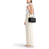 Black Tumi Voyageur Lex Train Case Crossbody Bag with gold accents, compact design, and adjustable strap.