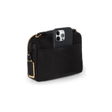 Black Tumi Voyageur Teghan crossbody bag with gold accents, featuring a sleek design and adjustable strap for versatile wear.