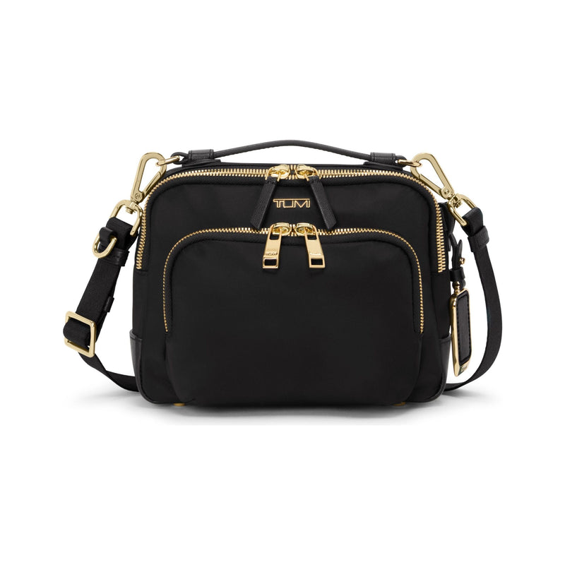 Black Tumi Voyageur Teghan Crossbody bag with gold accents, showing the sleek design and adjustable strap.