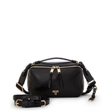 Black Tumi Voyageur Berlin crossbody bag with light gold accents, featuring a sleek design and adjustable strap.