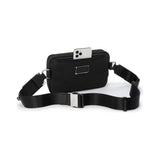 Tumi Arrivé Messina Utility Pouch sling bag with adjustable strap and multiple compartments, black nylon material.
