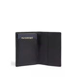 Tumi Alpha passport cover in black leather with silver accents, designed to protect and organize a travel document.
