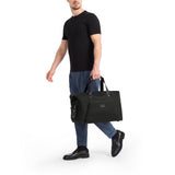 Tumi Alpha double expansion travel satchel with durable nylon exterior, multiple compartments, and leather handles for versatile travel use.