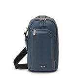Tumi Harrison Gregory Sling bag with adjustable strap, made of durable material, shown in a sleek, compact design.