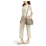 Taupe Tumi Georgica Marylea crossbody bag with adjustable strap and multiple compartments, showcasing sleek, stylish design.