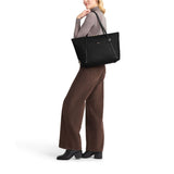 Black Tumi Voyageur Q Tote bag with gold accents, spacious design, and sturdy handles for versatile everyday use.