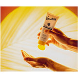 Vacation Classic Lotion SPF 30 bottle showing creamy lotion inside a white tube with a blue cap.