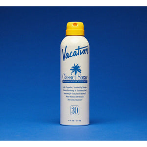 Vacation Classic Spray 30 SPF sunscreen bottle with white cap and orange label, designed for sun protection.