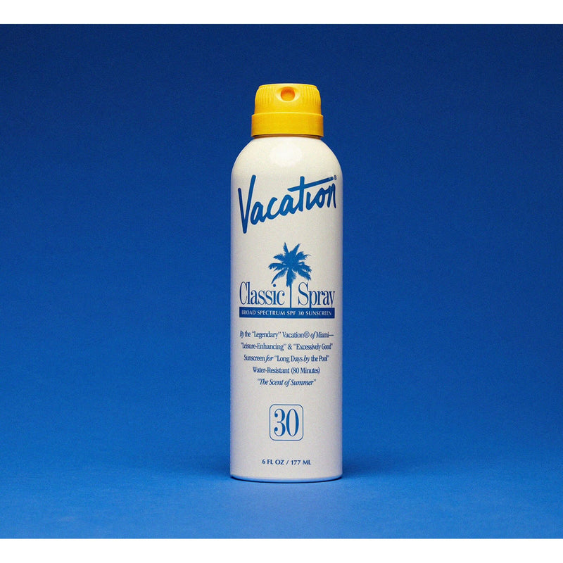 Vacation Classic Spray 30 SPF sunscreen bottle with white cap and orange label, designed for sun protection.
