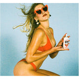 Vacation Classic Whip SPF 30 sunscreen lotion in a white bottle with a pump dispenser, designed for sun protection.