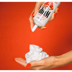 Bottle of Vacation Classic Whip SPF 30 sunscreen with a pump dispenser, featuring a sleek white container and clear branding.