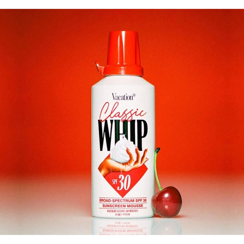 Bottle of Vacation Classic Whip SPF 30 sunscreen with white cap and label, showing the product's packaging and branding.