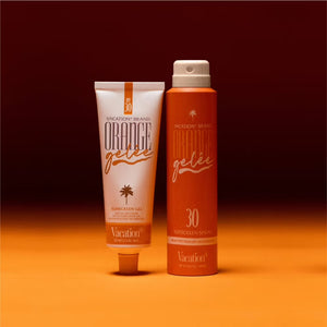 Bottle of Vacation Orange Gelée SPF 30 sunscreen with orange-themed packaging and label on a white background.