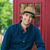 Natural beige Justin packable hat by Wallaroo Hat Company with wide brim and adjustable chin strap for sun protection.
