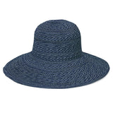Wallaroo Hat Company navy and white polka dot packable UPF 50+ hat with a matching scrunchie, designed for sun protection.