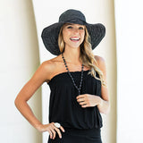 Navy and white dotted packable UPF 50+ hat by Wallaroo Hat Company with matching scrunchie, designed for sun protection and style.