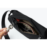 Bellroy Sling Mini compact sling bag with adjustable strap, made from durable material, shown with secure zipper compartments.