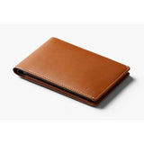Bellroy travel wallet in caramel color with multiple card slots and compartments, designed for secure, organized travel storage.