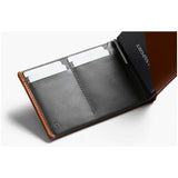 Bellroy travel wallet in caramel leather with multiple card slots and a sleek design, ideal for organizing travel essentials.