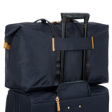 Bric's X-Collection 22-inch folding duffle bag in durable fabric with handles and zipper closure.