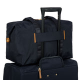 Bric's X-Collection 18-inch folding duffle bag in durable fabric with handles and zipper closure, designed for travel storage.
