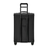 Briggs & Riley Baseline medium expandable spinner suitcase with four wheels and blue color, showing a sleek, durable travel luggage design.