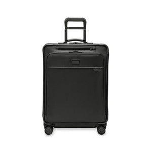Briggs & Riley Baseline medium expandable spinner suitcase with four wheels and blue color, showing its sleek design and sturdy handle.