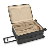 Briggs & Riley Baseline medium expandable spinner suitcase with blue hard shell, four wheels, and telescoping handle.