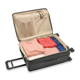 Briggs & Riley Baseline medium expandable spinner suitcase with blue color, four wheels, and telescopic handle for travel.