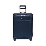 Briggs & Riley Baseline medium expandable spinner suitcase with blue fabric, four wheels, and telescoping handle for travel ease.