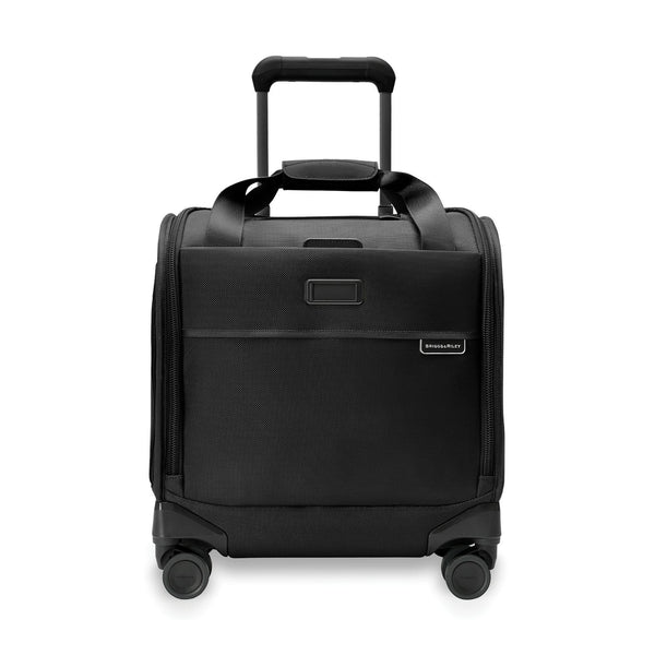 Briggs & Riley Baseline cabin spinner carry-on luggage in blue with four wheels and a telescopic handle, viewed from the side.