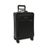 Briggs & Riley Baseline Essential Carry-On Spinner luggage in blue with four spinner wheels and a durable hard-shell exterior.