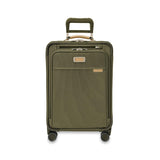 Briggs & Riley Baseline Essential Carry-On Spinner luggage in blue with four spinner wheels and a retractable handle.