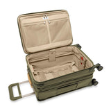 Briggs & Riley Baseline Essential Carry-On Spinner luggage in blue with four wheels and telescoping handle, ready for travel.