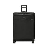 Briggs & Riley Baseline extra large expandable checked luggage spinner in blue, with four wheels and sturdy handle.