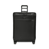 Briggs & Riley Baseline large expandable checked luggage spinner with blue hard shell exterior and multiple wheels for smooth rolling.