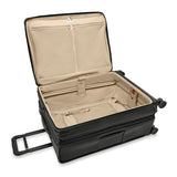 Briggs & Riley Baseline large expandable checked luggage spinner with blue hard shell and four wheels, open zipper showing interior compartments.