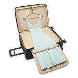 Briggs & Riley Baseline large expandable checked luggage spinner with blue hard shell and four wheels, ready for travel.