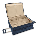 Briggs & Riley Baseline large expandable checked luggage spinner in blue with four wheels and telescoping handle.