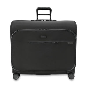 Briggs & Riley Baseline Deluxe Wardrobe Spinner garment bag with sturdy wheels, multiple compartments, and sleek navy blue exterior.