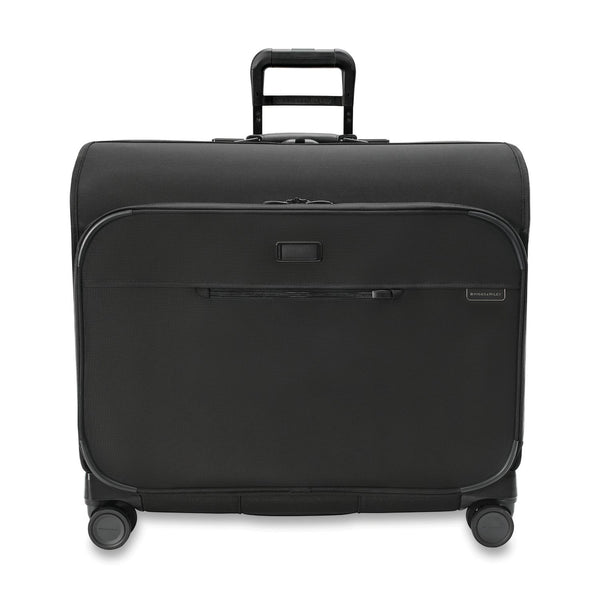Briggs & Riley Baseline Deluxe Wardrobe Spinner garment bag with sturdy wheels, multiple compartments, and sleek navy blue exterior.