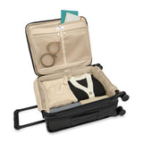 Briggs & Riley Baseline Global Carry-On Spinner luggage in blue with four spinner wheels and a telescoping handle.