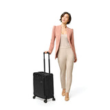 Blue Briggs & Riley Baseline Global Carry-On Spinner luggage with four spinner wheels and sturdy handle, designed for travel.