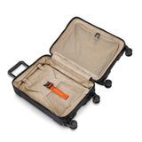 Briggs & Riley Torq domestic carry-on spinner suitcase with four wheels and durable hard shell, packed for travel.