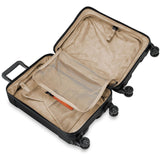 Briggs & Riley Torq domestic carry-on spinner suitcase with four wheels, black hard-shell exterior, and telescopic handle.