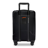 Briggs & Riley Torq domestic carry-on spinner suitcase with four wheels and hard shell, black color, side handle, and TSA lock.
