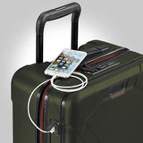 Briggs & Riley Torq international carry-on spinner suitcase with four wheels and built-in USB port for charging devices.