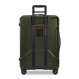 Briggs & Riley Torq medium spinner suitcase in stealth black with four spinner wheels and built-in handle for easy travel.